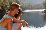 Young couple sitting by river, Hamburg, Pennsylvania, USA