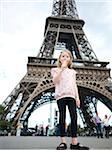 Girl eating Ice Cream Cone in front of Eiffel Tower, Paris, France