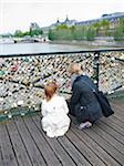 Mother and Daughter looking at Love Locks on Pont Des Arts, Paris, France