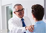 Businessman with hand on shoulder of apprentice in office, Germany