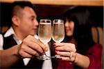 Close-up of couple toasting with champagne glasses, Ontario, Canada