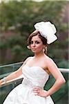 Close-up portrait of bride wearing wedding gown and fascinator, Ontario, Canada