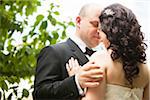 Close-up portrait of bride and groom standing outdoors, face to face, Ontario, Canada