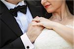 Close-up of bride and groom holding hands, Ontario, Canada