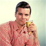 1960s MAN RED CHECKED SHIRT DRINKING BEER FROM PILSNER GLASS