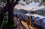 Sri Lankan people walking at Kandy Lake at sunrise, Kandy, Central Province, Sri Lanka, Asia