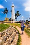 Tourist visiting Galle lighthouse in the Old Town of Galle, UNESCO World Heritage Site, Sri Lanka, Asia