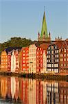 Nidaros Cathedral and old fishing warehouses reflected in the River Nidelva, Trondheim, Sor-Trondelag, Norway, Scandinavia, Europe