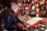 Young woman at the Christmas fair looking at Christmas decoration, Esslingen am Neckar, Baden Wurttemberg, Germany, Europe