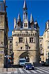 Mini Cooper car at Porte Cailhau 15th century entrance to city of Bordeaux marks victory of Charles VIII at Fornoue