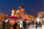 Snow-covered Christmas Market and Baroque St. Nicholas Church, Old Town Square, Prague, Czech Republic, Europe