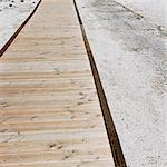 A boardwalk extending across the Midway Geyser in Yellowstone National Park.