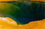 Detail of colourful water mineral deposits and rock formations from Midway Geyser, in Yellowstone National Park.