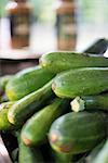 Organic vegetables on a farm stand. Piles of fresh courgettes.