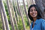 Trees on the shores of a lake. A woman standing in the shade.