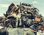 A heap of twisted metal, a scrap metal yard, a collection of objects for recycling.