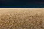 Tire tracks on the Bonneville Salt Flats. Speed Week. A dark stormy sky.