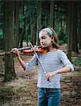 A ten year old girl playing the violin in Discovery Park, Seattle.