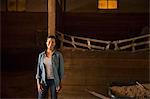 An organic farm in the Catskills. A woman in a horse stable.