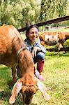 An organic farm in the Catskills. A woman with two large goats.