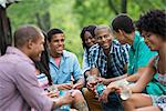 A group of men and women outdoors enjoying themselves.