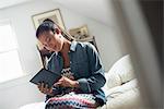 A young woman using a digital tablet.