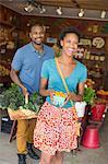 Two people in a farm shop, choosing organic vegetables.