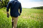 A farmer working in his fields in New York State, USA.