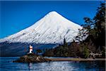 Scenic view of Todos los Santos Lake with lighthouse and Osorno Volcano, Parque Nacional Vicente Perez Rosales, Patagonia, Chile