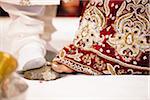 Bride and Groom Stepping on Stone during Hindu Wedding Ceremony, Toronto, Ontario, Canada
