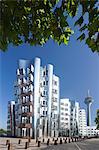 Neuer Zollhof, designed by Frank Gehry, and Rheinturm tower, Media Harbour (Medienhafen), Dusseldorf, North Rhine Westphalia, Germany, Europe