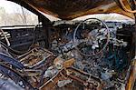 Inside burnt-out car wreck on road from Alice Springs,  Namatjira Drive, Northern Territory, Australia