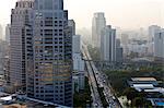 View of high rise buildings and traffic congestion on Rama IV in hazy evening light, from the roof of Hotel Sofitel So, Sathorn Road, Bangkok, Thailand, Southeast Asia, Asia