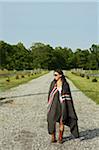 Young Women wrapped in Blanket on Country Road.