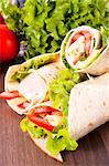 Fresh tortilla wrap sandwiches with vegetables and turkey