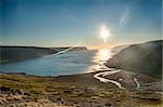 Sun is setting over the fjord on the Iceland