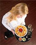 A Young Attractive Female Server Brings Wine and Appetizer Food Tray