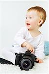 beautiful little blond baby with dslr camera