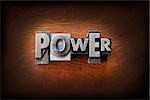 The word power made from vintage lead letterpress type on a leather background.