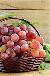 ripe red organic grapes in a basket on a wooden table