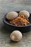 nutmeg whole and grated in a wooden bowl