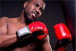 A boxer punches a heavy bag