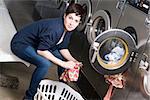 A woman toils at the laundromat