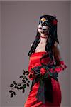 Sugar skull girl in red evening dress, Halloween shot