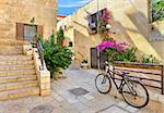 Bicycle on narrow street among typical stoned houses of jewish quarter in Old City of Jerusalem, Israel.