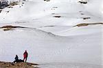 Two hikers on halt in snowy mountain. Turkey, Central Taurus Mountains, Aladaglar (Anti-Taurus), plateau Edigel (Yedi Goller).