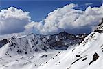 Snowy mountains and blue sky with cloud in sunny spring day. Turkey, Central Taurus Mountains, Aladaglar (Anti-Taurus), plateau Edigel (Yedi Goller)