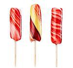 Set of twirled caramel candies on sticks, different colors. File includes clipping path