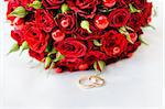 Wedding rings with a bouquet of roses