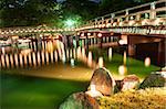 Nice japanese wooden bridge is shortly after the sunset reflecting in the water. Nara, Japan.